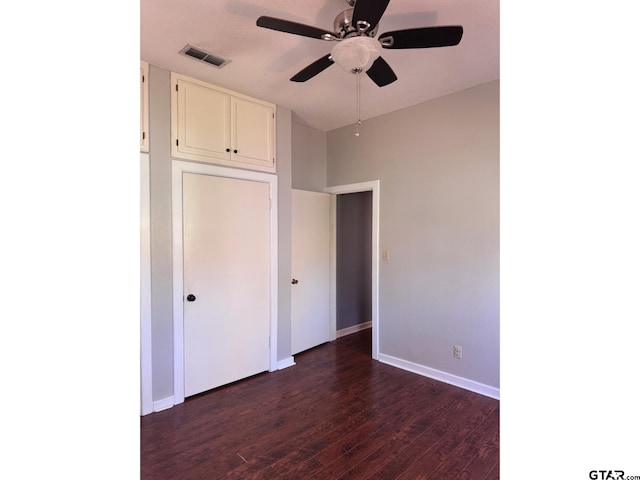 unfurnished bedroom featuring dark hardwood / wood-style floors and ceiling fan