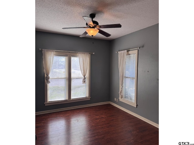 spare room featuring ceiling fan, dark hardwood / wood-style floors, and a textured ceiling