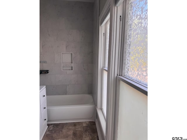 bathroom with vanity and a tub to relax in