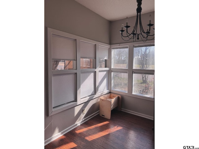 sunroom featuring a notable chandelier