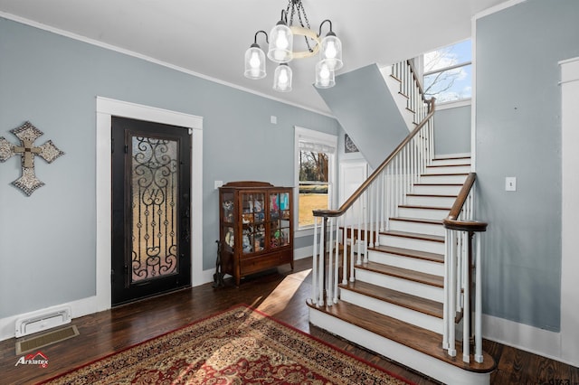 foyer featuring stairs, wood finished floors, and a wealth of natural light