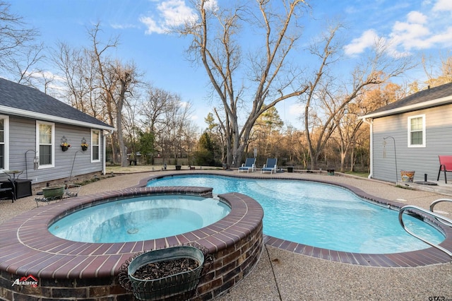 view of pool with a pool with connected hot tub and a patio