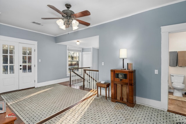 interior space with crown molding, baseboards, visible vents, and french doors