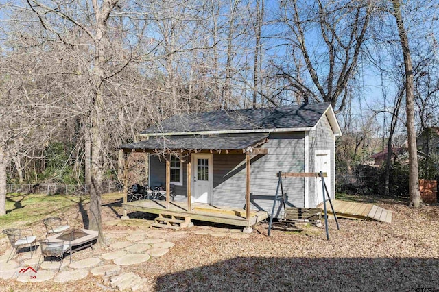 view of outdoor structure with an outbuilding and a fire pit