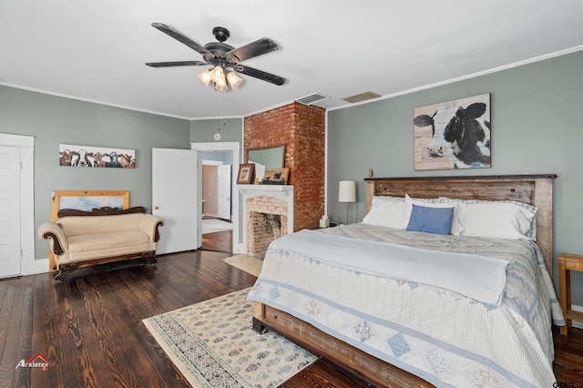 bedroom with visible vents, a fireplace with flush hearth, ornamental molding, a ceiling fan, and wood finished floors