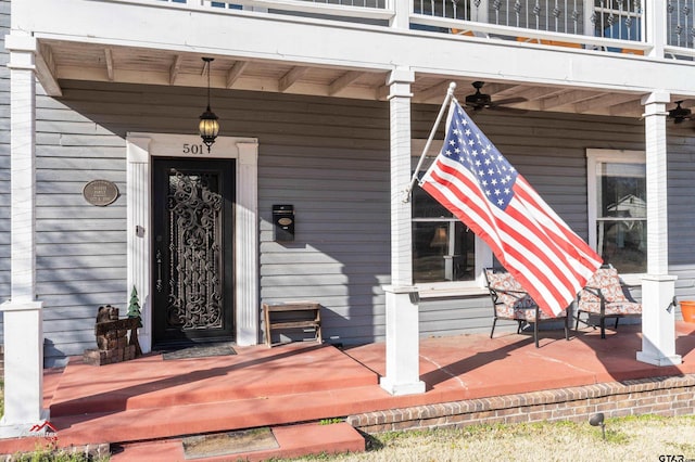 entrance to property featuring a balcony and covered porch