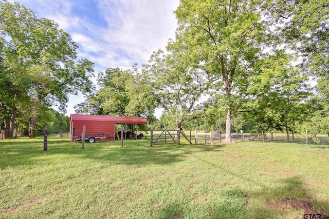 view of yard featuring a carport and a rural view