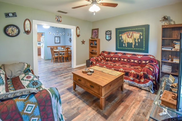 living room featuring wood-type flooring and ceiling fan