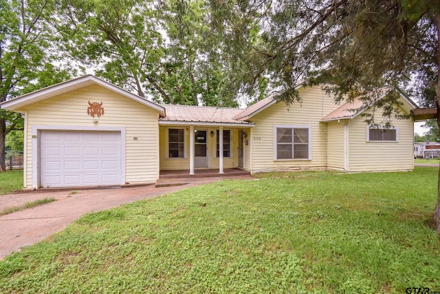 single story home with a garage and a front lawn