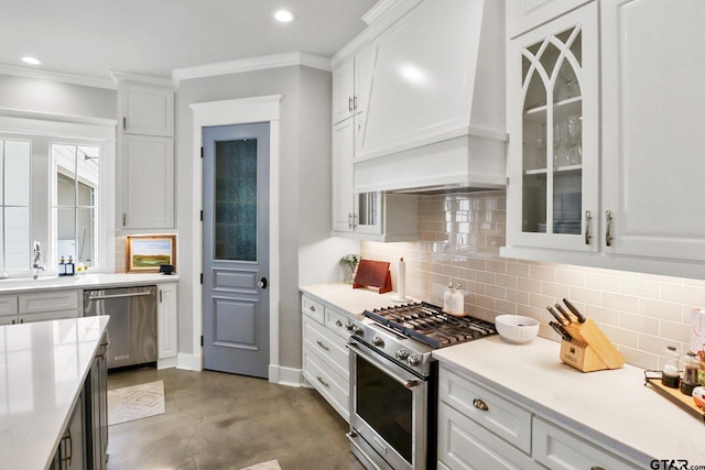 22302 County Road 422, Lindale, TX 75771 - kitchen with appliances with stainless steel finishes, custom range hood, concrete flooring, white cabinetry, and backsplash