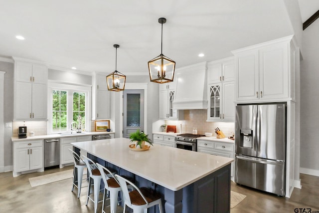 22302 County Road 422, Lindale, TX 75771 - kitchen featuring stainless steel appliances, custom range hood, finished concrete flooring, backsplash, and white cabinets