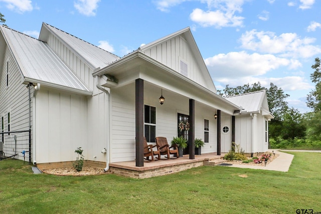 22302 County Road 422, Lindale, TX 75771 - view of front facade with a porch, a front yard, a metal roof, and board and batten siding