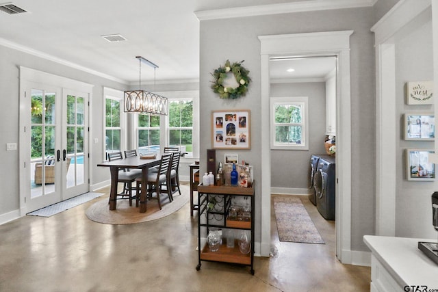 22302 County Road 422, Lindale, TX 75771 - dining area featuring washing machine and clothes dryer, ornamental molding, finished concrete flooring, french doors, and a chandelier