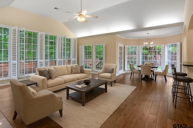 5405 Ashbury Ct, Tyler, TX 75703 - living area featuring a chandelier, ceiling fan, wood finished floors, healthy amount of natural light, and vaulted ceiling
