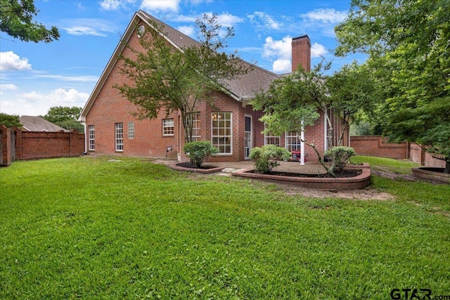 5405 Ashbury Ct, Tyler, TX 75703 - back of property with brick siding, a chimney, and roof with shingles