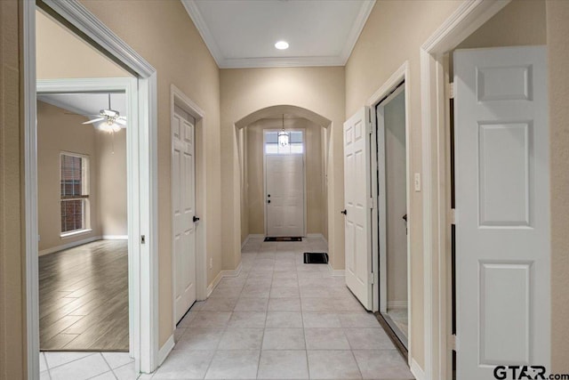 5405 Ashbury Ct, Tyler, TX 75703 - hallway with arched walkways, ornamental molding, light tile patterned floors, and recessed lighting