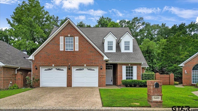 5405 Ashbury Ct, Tyler, TX 75703 - traditional-style home with concrete driveway, a front lawn, brick siding, an attached garage, and roof with shingles