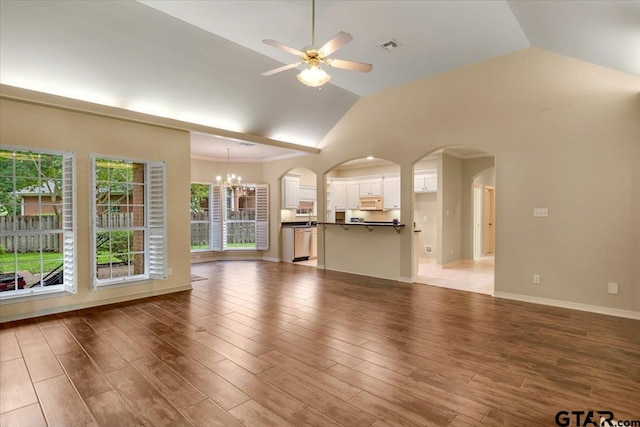 5405 Ashbury Ct, Tyler, TX 75703 - unfurnished living room with vaulted ceiling, a chandelier, a ceiling fan, arched walkways, and wood finished floors