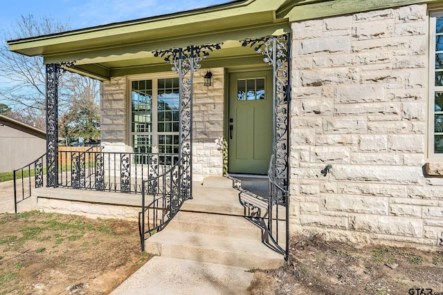 view of exterior entry with a porch