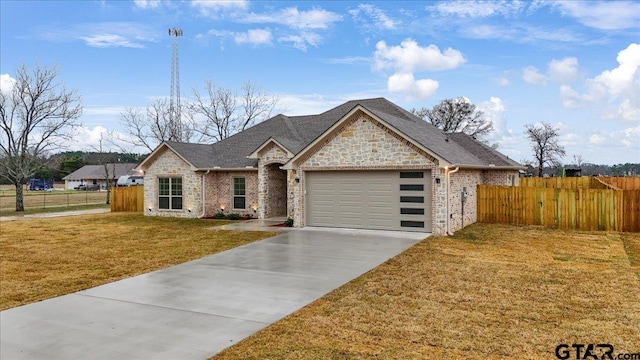 view of front of house with a garage and a front yard