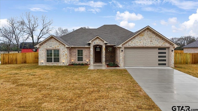 view of front of home with a garage and a front yard