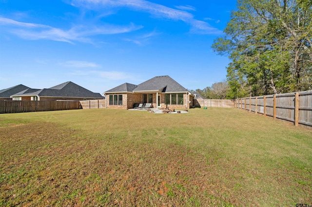 back of property with a yard and a patio