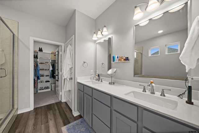 bathroom with vanity, hardwood / wood-style flooring, and a shower with shower door