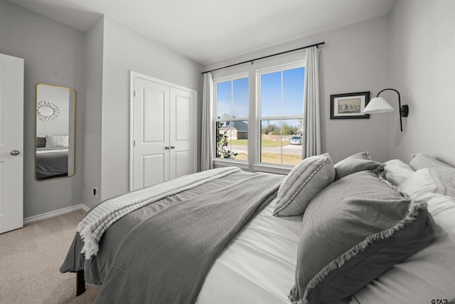 carpeted bedroom with a closet