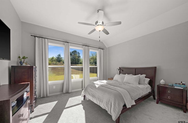 carpeted bedroom with ceiling fan and lofted ceiling