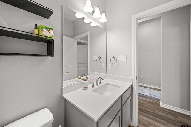 bathroom featuring vanity, toilet, and wood-type flooring