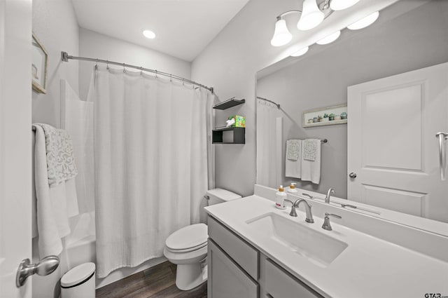 full bathroom with shower / bathtub combination with curtain, vanity, toilet, and wood-type flooring