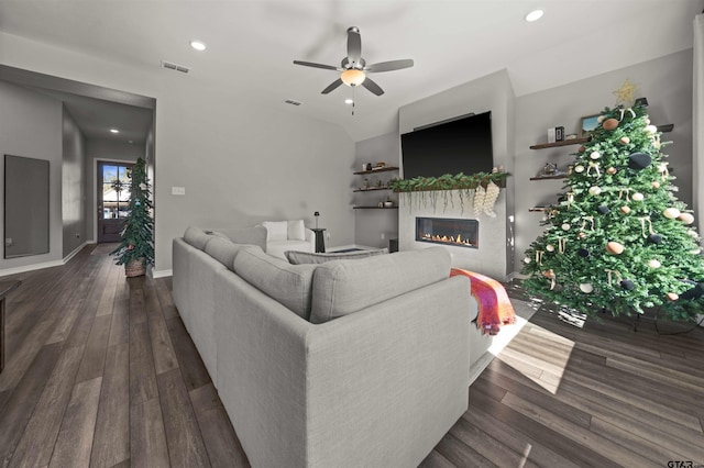 living room with ceiling fan and dark wood-type flooring