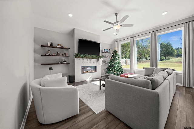 living room featuring dark hardwood / wood-style flooring, plenty of natural light, and ceiling fan