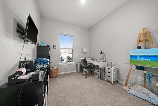 carpeted home office with lofted ceiling