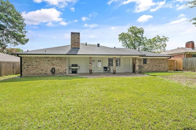 7411 Hollyoak Dr, Tyler, TX 75703 - back of property with a patio area, french doors, brick siding, and a chimney