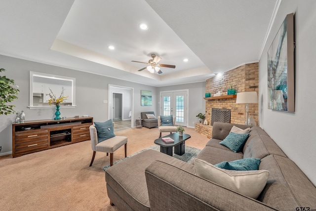 7411 Hollyoak Dr, Tyler, TX 75703 - living area with light carpet, a raised ceiling, ceiling fan, recessed lighting, and a brick fireplace