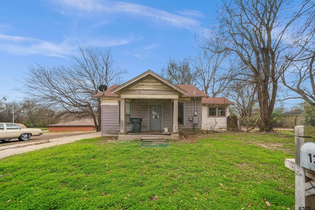 bungalow-style home featuring a front yard