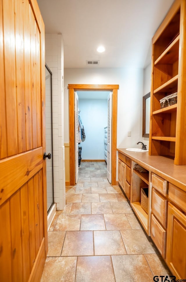5646 Fm 346, Tyler, TX 75703 - full bathroom featuring visible vents, a shower stall, vanity, and stone tile floors
