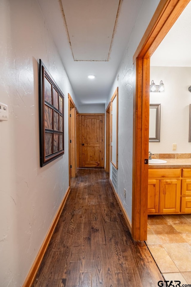 5646 Fm 346, Tyler, TX 75703 - corridor featuring a sink, baseboards, and wood finished floors