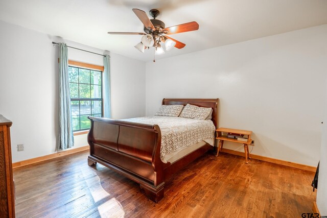 5646 Fm 346, Tyler, TX 75703 - bedroom with baseboards, a ceiling fan, and wood finished floors