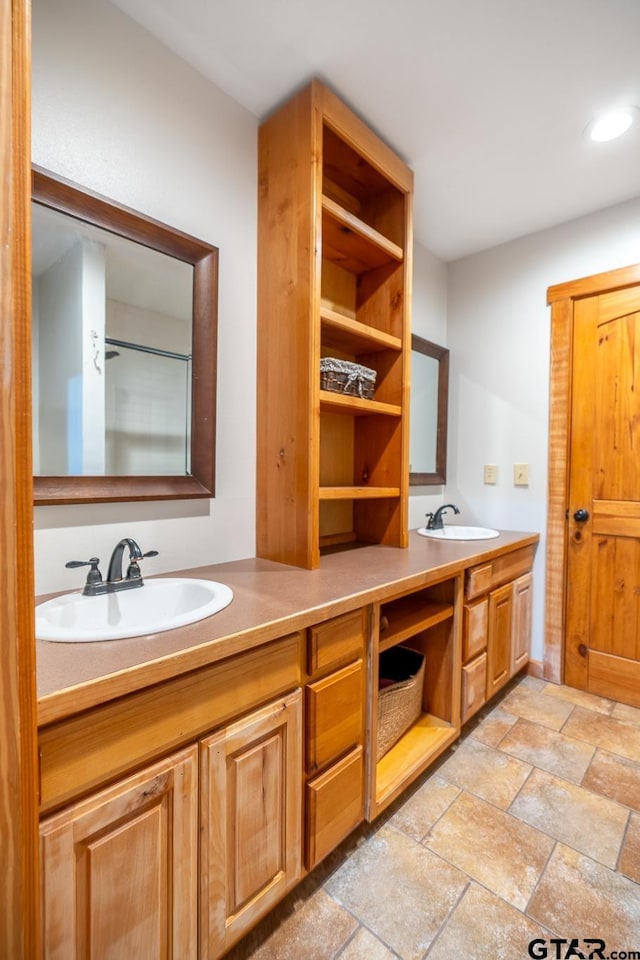 5646 Fm 346, Tyler, TX 75703 - full bathroom featuring double vanity, a sink, stone tile flooring, and recessed lighting