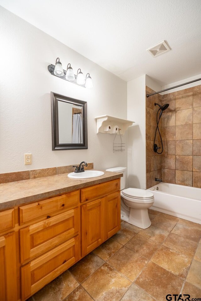 5646 Fm 346, Tyler, TX 75703 - bathroom with vanity, bathing tub / shower combination, toilet, stone finish floor, and visible vents