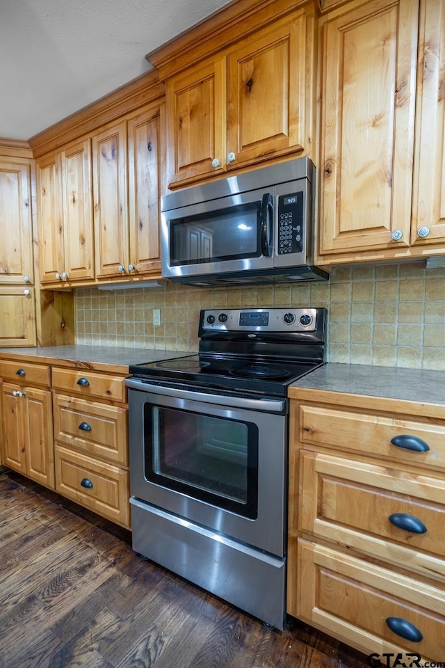 5646 Fm 346, Tyler, TX 75703 - kitchen with dark wood-style flooring, decorative backsplash, and appliances with stainless steel finishes