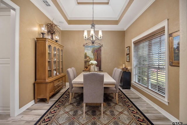 5875 Stonegate Trl, Tyler, TX 75703 - dining space featuring a chandelier, light wood-type flooring, ornamental molding, a textured wall, and baseboards