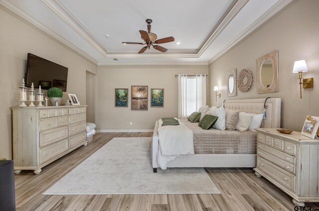 5875 Stonegate Trl, Tyler, TX 75703 - bedroom with a tray ceiling, light wood-style floors, crown molding, ceiling fan, and baseboards