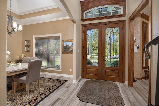 5875 Stonegate Trl, Tyler, TX 75703 - entryway with a chandelier, french doors, light wood-type flooring, crown molding, and baseboards