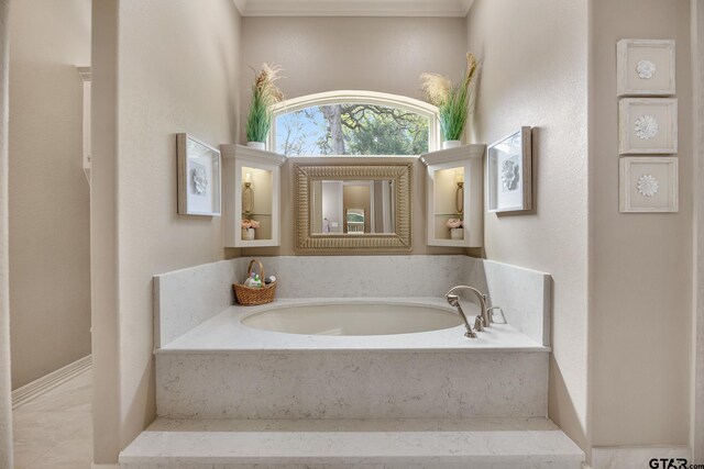 5875 Stonegate Trl, Tyler, TX 75703 - bathroom featuring a bath and ornamental molding