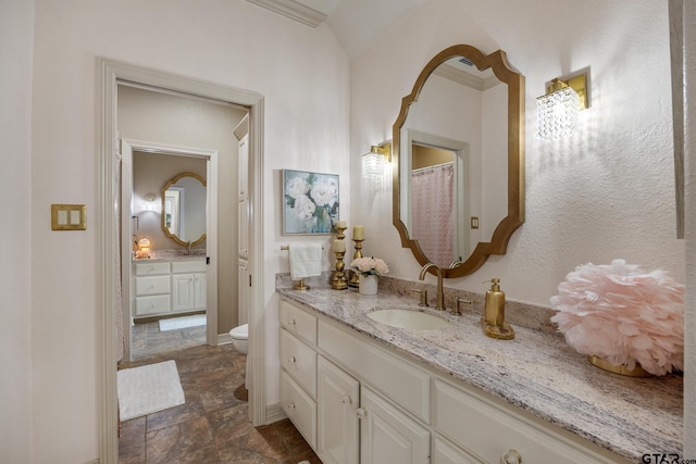 5875 Stonegate Trl, Tyler, TX 75703 - full bathroom with vanity, toilet, stone finish flooring, and baseboards