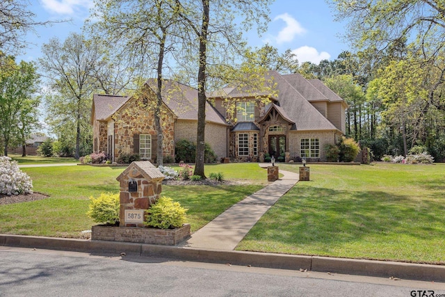 5875 Stonegate Trl, Tyler, TX 75703 - view of front of home with a front yard and stone siding