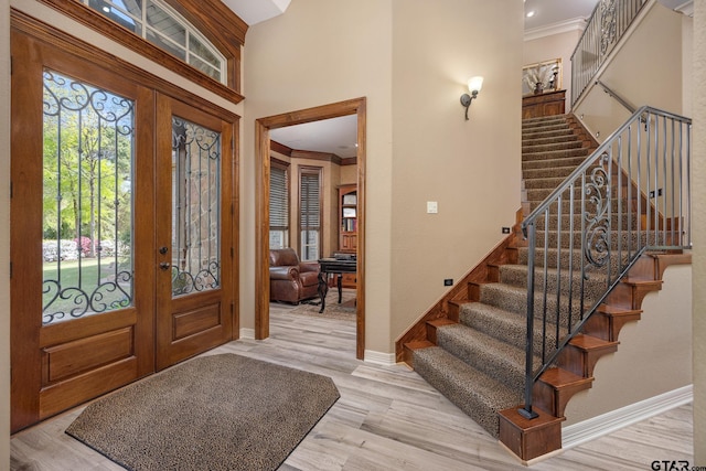 5875 Stonegate Trl, Tyler, TX 75703 - entrance foyer featuring french doors, ornamental molding, stairs, wood finished floors, and baseboards